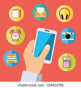 Hand holding cell phone with icons: headphones, photo camera, mail, alarm clock, library books, calculator, organizer