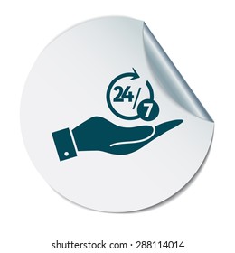 hand holding a character 24 7 sign.