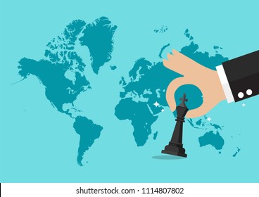 Hand holding chess figure with world map background. Business strategy concept