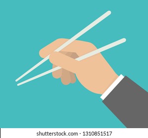 Hand holding chopsticks
