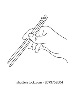 Hand is holding chopsticks, black linear sketch isolated on white background.