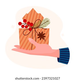 Hand holding christmas box gift cartoon vector illustration. Present in hand. Cartoon gift box with branch fir tree, red berry and anise star.	