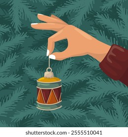 A hand holding a Christmas drum ornament. Vector background with fir branches. Holiday preparation.