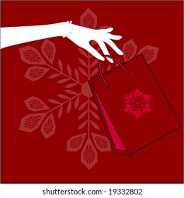 hand holding christmas shopping bag
