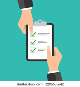 Hand holding clipboard checklist