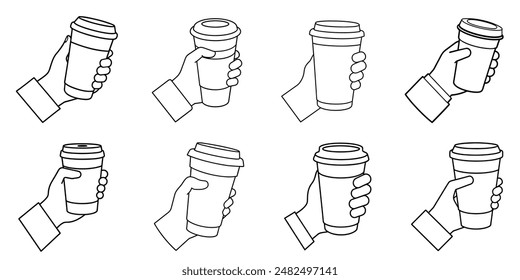 A hand is holding a coffee cup