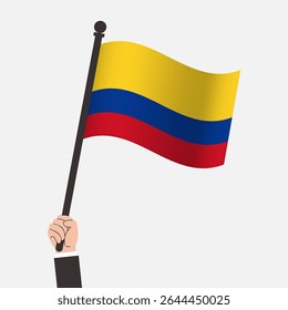 Mão segurando bandeira de agitação da Colômbia