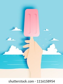 Hand holding a colorful popsicle in paper art style with pastel scheme beach and sky background vector illustration