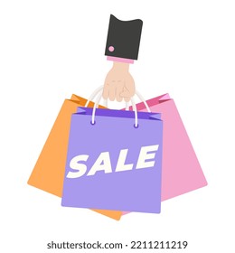 Hand holding colorful Shopping or gift Bags. Sale sign. Shopping bags.