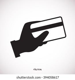 hand holding credit card black icon. Credit card payment icon vector. Isolated on White Background