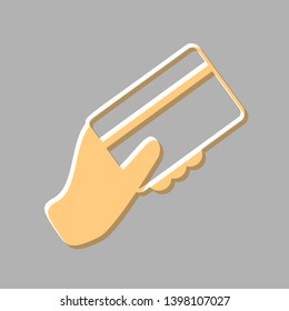 Hand holding a credit card. Emboss effect with light orange icon on gray background.