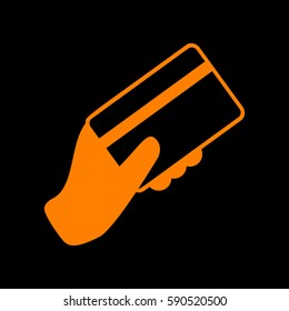 Hand holding a credit card. Orange icon on black background.