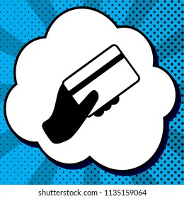 Hand holding a credit card. Vector. Black icon in bubble on blue pop-art background with rays.