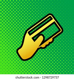 Hand holding a credit card. Vector. Pop art orange to yellow dots-gradient icon with black contour at greenish background.