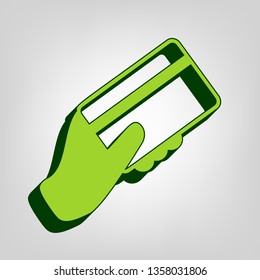 Hand holding a credit card. Vector. Yellow green solid icon with dark green external body at light colored background.
