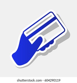 Hand holding a credit card. Vector. New year bluish icon with outside stroke and gray shadow on light gray background.