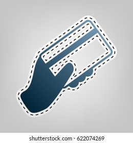 Hand holding a credit card. Vector. Blue icon with outline for cutting out at gray background.