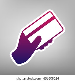 Hand holding a credit card. Vector. Purple gradient icon on white paper at gray background.