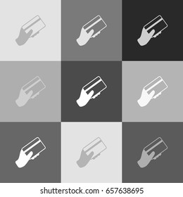 Hand holding a credit card. Vector. Grayscale version of Popart-style icon.