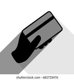 Hand holding a credit card. Vector. Black icon with two flat gray shadows on white background.