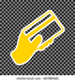 Hand holding a credit card. Vector. Yellow icon with white contour on dark transparent background.