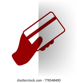 Hand holding a credit card. Vector. Bordo icon on white bending paper background.