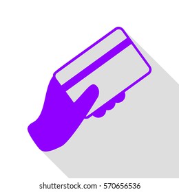Hand holding a credit card. Violet icon with flat style shadow path.