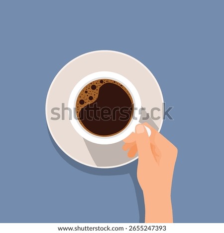 Hand holding a cup of coffee top view