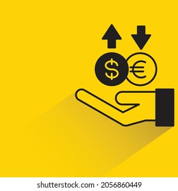 hand holding currency hedging with shadow on yellow background