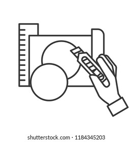 hand holding cutter making circle with paper