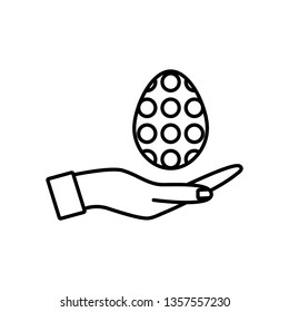 Hand holding a decorated Easter egg; thin line vector icon, linear graphic symbol isolated on white. Easter design