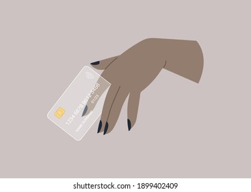 A hand holding a designer transparent plastic credit card, wireless transactions
