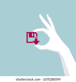 Hand holding a disk drive, hand is white, disk is red.
