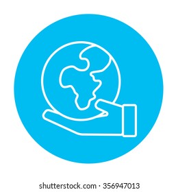 Hand holding the Earth line icon for web, mobile and infographics. Vector white icon on the light blue circle isolated on white background.