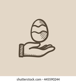 Hand holding easter egg vector sketch icon isolated on background. Hand drawn Hand holding easter egg icon. Hand holding easter egg sketch icon for infographic, website or app.