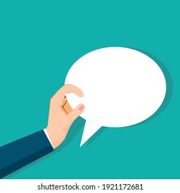 Hand holding an empty speech bubble on background