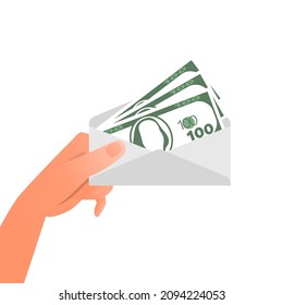 Hand is holding envelope with dollar banknotes. Corruption concept
