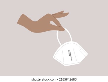 A hand holding a FFP2 protective mask