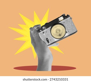 a hand holding a film camera