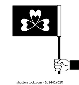 hand holding flag with clover symbol