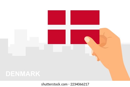 Hand holding the flag of Denmark on the background of the city in minimal flat style. Vector illustration