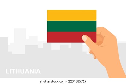 Hand holding the flag of Lithuania on the background of the city in minimal flat style. Vector illustration