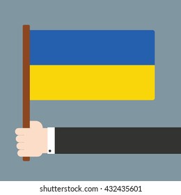 Hand holding flag Ukraine
