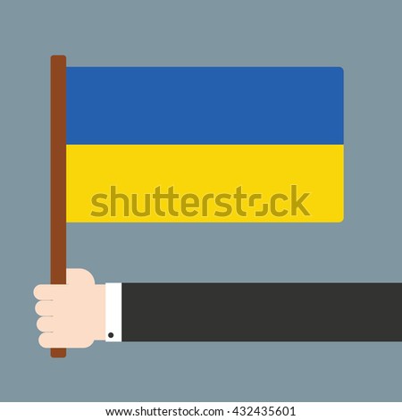 Hand holding flag Ukraine