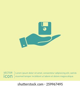 hand holding a floppy, diskette. symbol store information document. computer floppy disk icon .