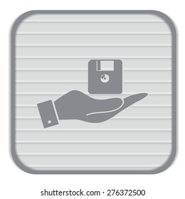 hand holding a floppy, diskette. symbol store information document. computer floppy disk icon .