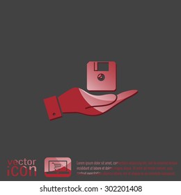 hand holding a floppy, diskette. symbol store information document. computer floppy disk icon .
