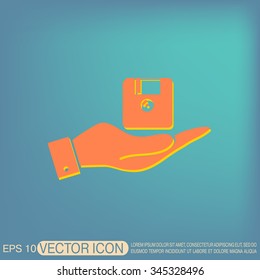 hand holding a floppy, diskette. symbol store information document. computer floppy disk icon .