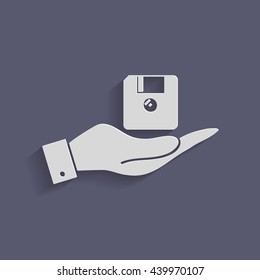 hand holding a floppy, diskette. symbol store information document. computer floppy disk icon .