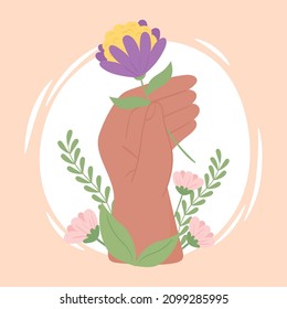 hand holding a flower with foliage